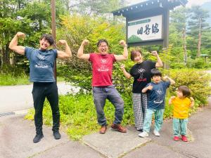 a group of people with their arms in the air at 筋肉と自然と遊ぶ宿 田島館 in Takayama
