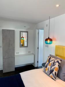 a bedroom with a bed and a pendant light at Modern studio apartment with stunning views! in St Ives