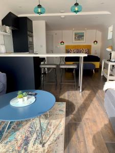 a living room and kitchen with a table and a couch at Modern studio apartment with stunning views! in St Ives