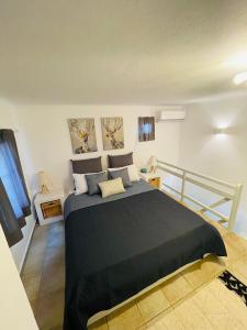 a bedroom with a large bed with a black blanket at Egea House in Stelida
