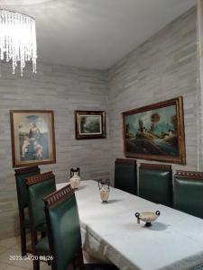 a dining room with a table and chairs and a chandelier at B&B Gardasee in Castelnuovo del Garda