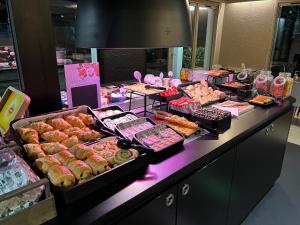 a buffet line with many different types of pastries at Campanile Rouen Sud - Cléon Elbeuf in Cléon