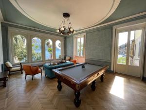 a large room with a pool table in it at Beach Villa Fiorina in Ghiffa