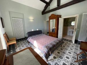 a bedroom with a bed and a dresser in it at Beach Villa Fiorina in Ghiffa