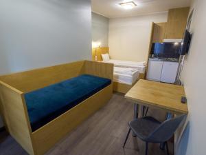 a small room with a bed and a table at Central City Apartments in Oslo