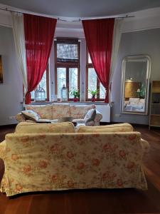 a living room with a couch and a large window at Charlotte Apartment in Tarnów