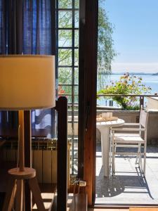 a room with a table and a view of the ocean at APPARTAMENTO GHITA in Baveno