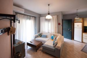 a living room with a couch and a table at Stella's Beach House in Nikiti