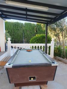 a pool table sitting under a pergola at Casa Olivar B&B in Tocon