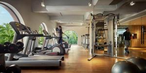 a gym with a bunch of treadmills and machines at PARKROYAL Penang Resort in Batu Ferringhi