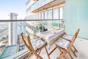 a dining room with a table and chairs and a large window at Breathtaking sea-view condo in Dubai Marina - Palm Views! in Dubai