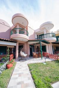 a house with two balconies on top of it at Stella's Beach House in Nikiti