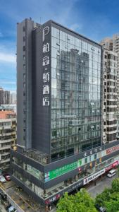 a tall building with a sign on the side of it at Paco Hotel GuangZhou Zoo Metro Branch-Free Shuttle Bus for Canton Fair in Guangzhou