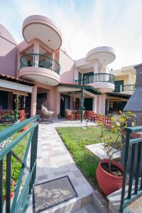 a building with two balconies on top of it at Stella's Beach House in Nikiti