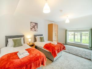 a bedroom with two beds and a window at Northstead Lodge in Flamborough