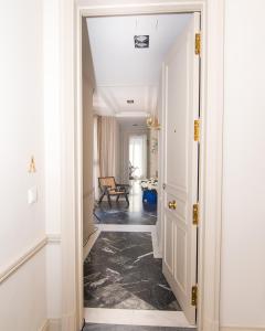 a hallway with white walls and a hallway with black flooring at The Ultimate Home of Eurovision with Blas Cantó in Madrid