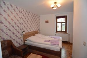 a small bedroom with a bed and a window at Apartament Supercentral Sibiu in Sibiu