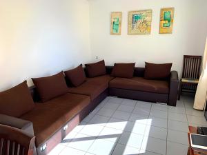 una sala de estar con un sofá marrón en una habitación en Spectacular Sea views 2 bedrooms in Villa Marina, en Benidorm