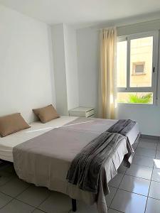 1 dormitorio con 2 camas y ventana en Spectacular Sea views 2 bedrooms in Villa Marina, en Benidorm