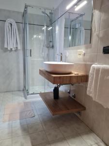 a bathroom with a sink and a shower at Manfredi ristorante con alloggio in Romentino