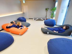 two children laying in bean bags in a room at LC Goryokaku Hotel in Hakodate