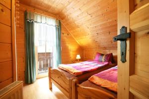 a bedroom with a bed in a log cabin at Almliesl KATH-631 