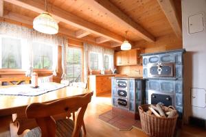 a kitchen with a stove and a wooden ceiling at Almliesl KATH-631 