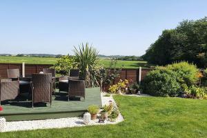 a patio with a table and chairs in a yard at Self-contained annex with private entrance, double bed, kitchen, bathroom, free car park - Near Cambridge, Duxford Air Museum and Addenbrooke's Hospital in Cambridge