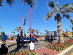 a group of people watching a man on a swing at Port Said Tourist Resort in Port Said