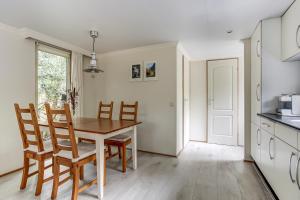 a kitchen and dining room with a table and chairs at Norgerchalet in Norg