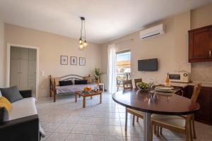 a kitchen and living room with a table and a couch at Nafplio view in Nafplio