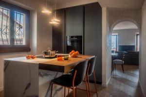 a kitchen with a island with oranges on it at Leoni 7 in Menaggio