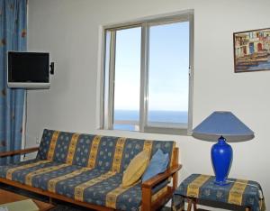 a couch sitting in a living room with a window at Villas Michalis in Chorafakia