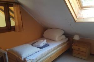 a bed in a room with two pillows and a window at Mazot d'antan in Saint-Sixt