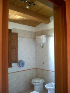 a bathroom with a toilet and a sink at Società Agricola MG Florplant in Francavilla Marittima