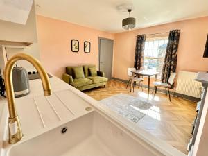 a kitchen and living room with a sink and a couch at The Hudson in Market Weighton