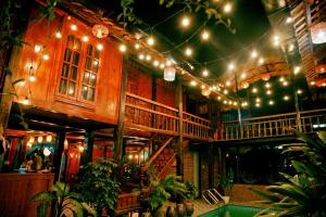 a building with a string of lights and a pool at Ninh Binh Green Homestay in Ða Gia