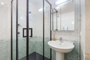 a bathroom with a sink and a shower at Conseil B - Chic 2BR City Center Apartment - Free Parking & Mountain View - By Cozee Rentals in Saint-Gervais-les-Bains +19 photos