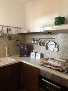 a kitchen with a sink and a counter top at Villa Catia in Alberobello