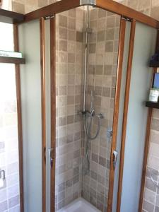 uma casa de banho com um chuveiro e uma porta de vidro em Villa Catia em Alberobello