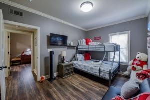 a bedroom with a bunk bed and a living room at Elephant Stomp in Tuscaloosa