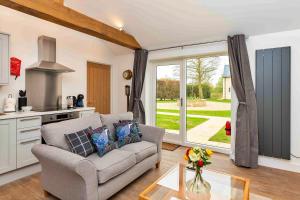 a living room with a couch and a kitchen at Finest Retreats - The Sett in Stamford
