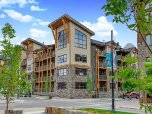 an apartment building in the middle of a street at White Spruce Condo by Gordon Property Management in Canmore