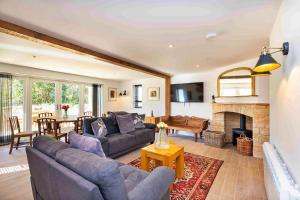 a living room with a couch and a fireplace at Finest Retreats - The Roost in Stamford