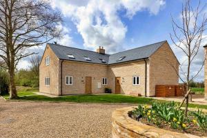 a large brick house with a roof at Finest Retreats - The Roost in Stamford