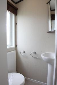 a bathroom with a toilet and a sink at Countryside Holiday Park by the River nr Canterbury (Pet-Friendly) in Canterbury