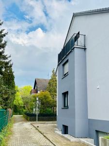 a white building with a balcony on the side of it at Ruheoase - Premium Suite in Karlsruhe