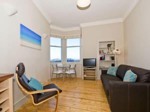a living room with a couch and a table at Seabreeze in North Berwick
