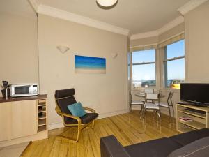 a living room with a couch and chairs and a table at Seabreeze in North Berwick
