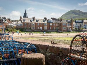 a view of a beach and a building with people on it at Seabreeze in North Berwick